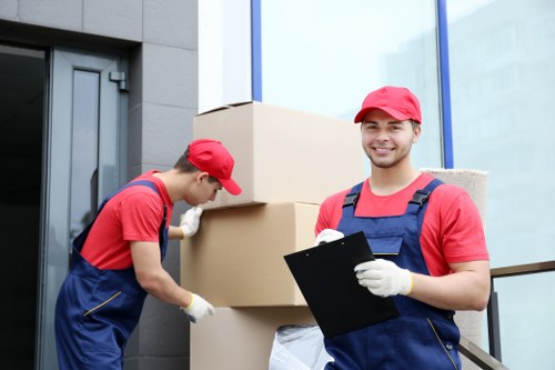 Packed boxes and furniture ready for loading into a van