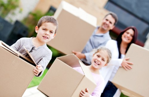 Professional movers loading a van on a Longlands street