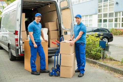 Loading furniture and boxes into a van for removals in Longlands