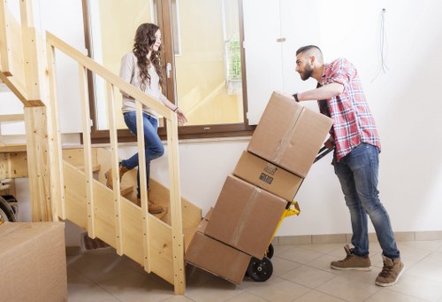 Moving van and crew handling access challenges on a Longlands street