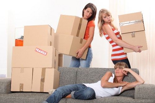 Man with van team handling furniture carefully during loading